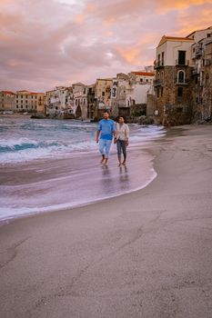 Cefalu, the medieval village of Sicily island, Province of Palermo, Italy. Europe, a couple on vacation at the Italian Island Sicilia