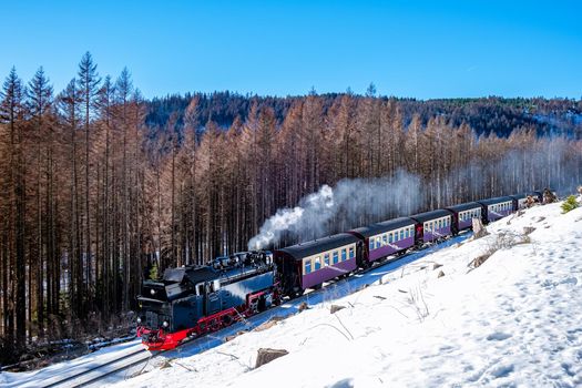 Harz national park Germany, Steam train on the way to Brocken through the winter landscape, Famous steam train through the winter mountain. Brocken, Harz National Park Mountains in Germany Europe