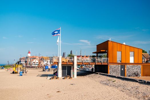 Urk Netherlands August 2020, harbor and lighthouse near the beach on a bright summer day Flevoland Urk Netherlands Europe, new restaurant pavilion on the beach