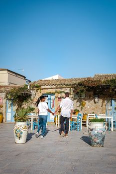 The picturesque village of Marzamemi, in the province of Syracuse, Sicily Italy, a couple on vacation in Sicilia