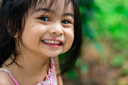 Pretty little girl close up shot while smiling and shoeing her cute teeth