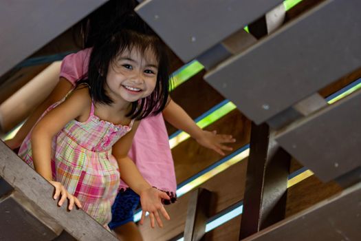 Pretty asian identical twins while enjoying and playing on a playground