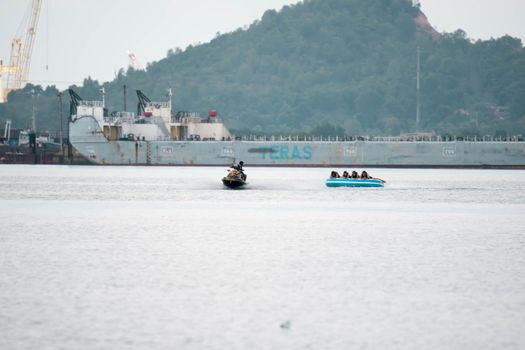 Beach water sports tubing with tourist being pulled by jetski in a beach in batam indonesia, Indonesia, May 4 2019