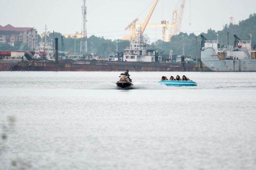Beach water sports tubing with tourist being pulled by jetski in a beach in batam indonesia, Indonesia, May 4 2019