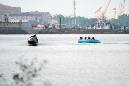 Beach water sports tubing with tourist being pulled by jetski in a beach in batam indonesia, Indonesia, May 4 2019