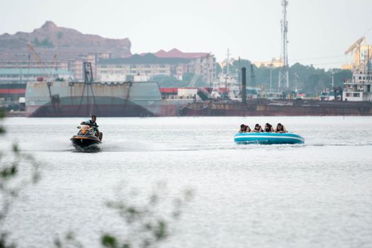 Beach water sports tubing with tourist being pulled by jetski in a beach in batam indonesia, Indonesia, May 4 2019