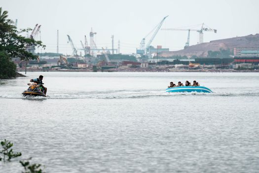Beach water sports tubing with tourist being pulled by jetski in a beach in batam indonesia, Indonesia, May 4 2019