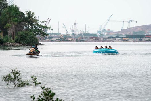 Beach water sports tubing with tourist being pulled by jetski in a beach in batam indonesia, Indonesia, May 4 2019