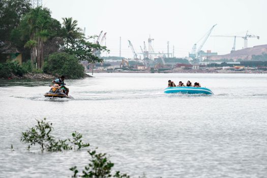 Beach water sports tubing with tourist being pulled by jetski in a beach in batam indonesia, Indonesia, May 4 2019
