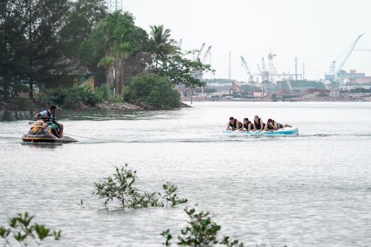 Beach water sports tubing with tourist being pulled by jetski in a beach in batam indonesia, Indonesia, May 4 2019