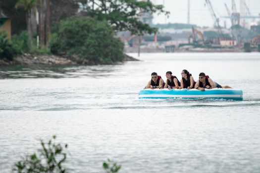 Beach water sports tubing with tourist being pulled by jetski in a beach in batam indonesia, Indonesia, May 4 2019