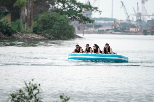 Beach water sports tubing with tourist being pulled by jetski in a beach in batam indonesia, Indonesia, May 4 2019