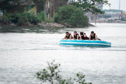 Beach water sports tubing with tourist being pulled by jetski in a beach in batam indonesia, Indonesia, May 4 2019