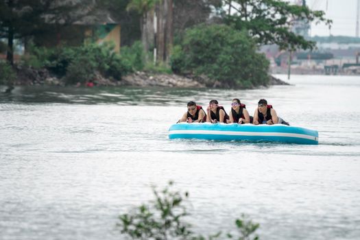 Beach water sports tubing with tourist being pulled by jetski in a beach in batam indonesia, Indonesia, May 4 2019