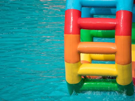 Swimming pool water sports large wheel tubing. Colorful water wheel tubing in a swimming pools