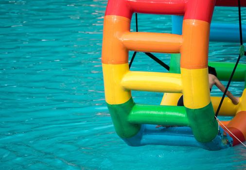 Swimming pool water sports large wheel tubing. Colorful water wheel tubing in a swimming pools