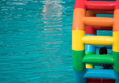 Swimming pool water sports large wheel tubing. Colorful water wheel tubing in a swimming pools