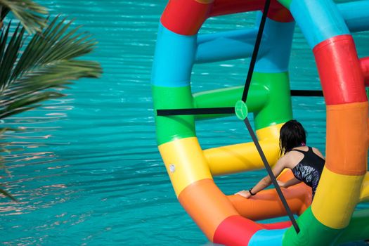 Swimming pool water sports large wheel tubing. Colorful water wheel tubing in a swimming pools