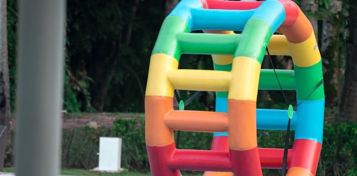 Swimming pool water sports large wheel tubing. Colorful water wheel tubing in a swimming pools