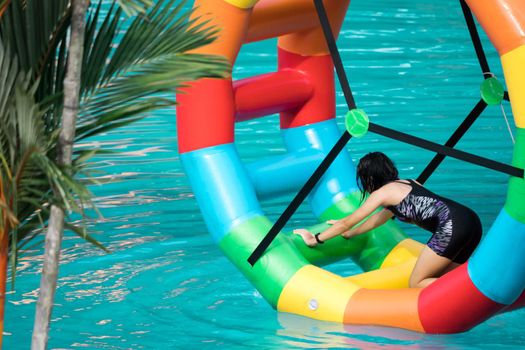 Swimming pool water sports large wheel tubing. Colorful water wheel tubing in a swimming pools