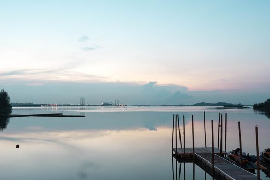 Beach landscape view with wooden foot bridge during sunset. Beatiful screnery of a beach with ocean and sky and water reflections