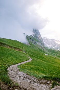  hiking in the Italien Dolomites, Amazing view on Seceda peak. Trentino Alto Adige, Dolomites Alps, South Tyrol, Italy, Europe. Odle mountain range, Val Gardena. Majestic Furchetta peak in morning sunlight. Italy