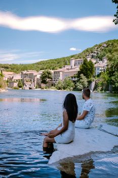 couple on vacation in Ardeche France, view of the village of Vogue in Ardeche. France Europe