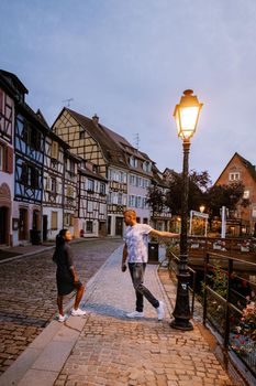 couple on city trip Colmar, Alsace, France. Petite Venice, water canal and traditional half timbered houses. Colmar is a charming town in Alsace, France. Beautiful view of colorful romantic city Colmar