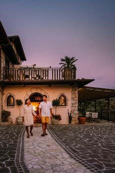 Luxury country house with swimming pool in Italy. Pool and old farm house during sunset central Italy. Couple on Vacation at luxury villa in Italy, men and woman watching sunset