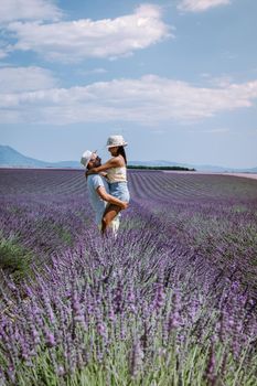 Provence, Lavender field France, Valensole Plateau, colorful field of Lavender Valensole Plateau, Provence, Southern France. Lavender field. Europe. Couple men and woman on vacation at the provence lavender fields,