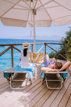 Crete Greece couple by the ocean on a sunbed by the ocean on the beach of Crete Greece. 