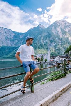 men visit during summer vacation Hallstatt village on Hallstatter lake in Austrian Alps Austria Europe