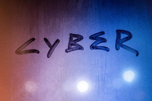 the word cyber handwritten on night wet glass surface, close-up conceptual background