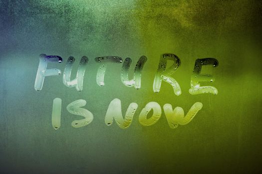 words future is now handwritten on night foggy window glass surface, close-up with selective focus