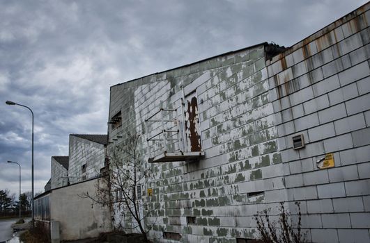 Old industrial area, cold winter day, cloudy sky, green old building