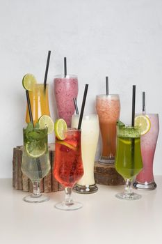 Fruit juice cocktails on a wood stump