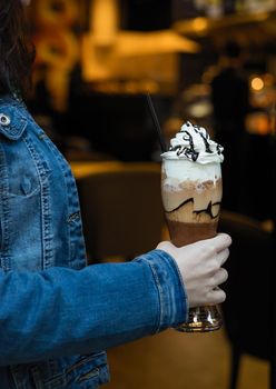 Woman holding cold chocolate milky cocktail
