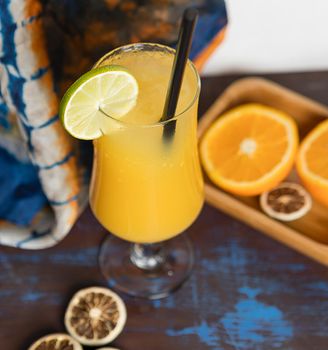 Orange fruit cocktail with lemon close up