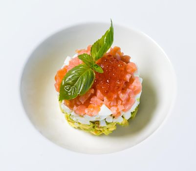 Red caviar meal in the white plate close up