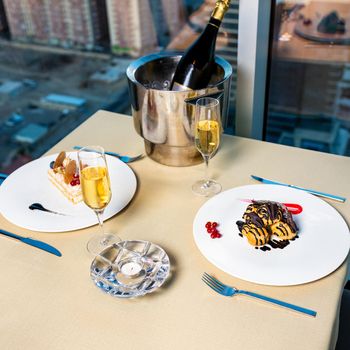 Tasty chocolate cake with wine bottle at restaurant