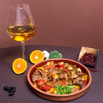 Tasty meat meal with white wine glass