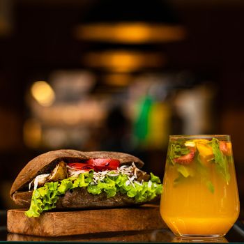 Beef meat sandwich with orange cocktail juice