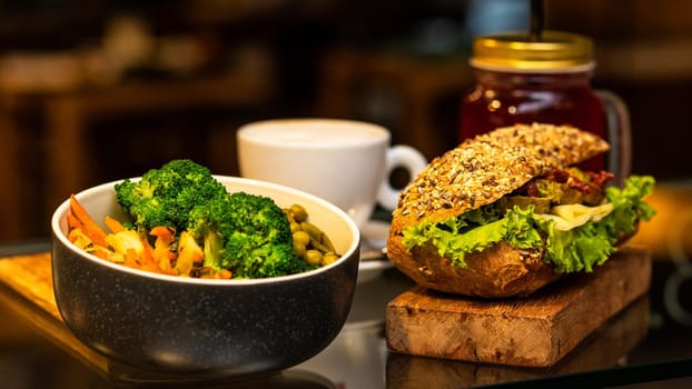 Tasty meat salad with sandwich, coffee, juice, plant