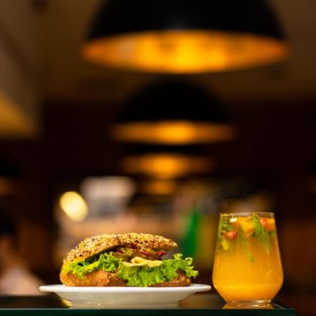 Beef meat sandwich with orange cocktail juice