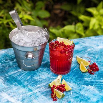 Lingonberry fruit with lime and ice in bucket