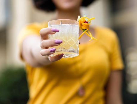 Woman holding a beautiful alcoholic cocktail glass