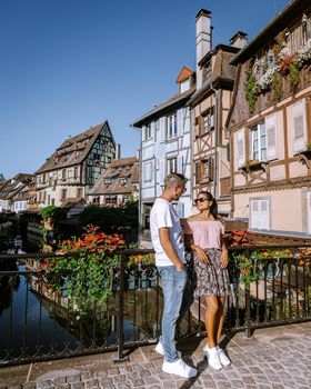 couple on city trip Colmar, Alsace, France. Petite Venice, water canal and traditional half timbered houses. Colmar is a charming town in Alsace, France. Beautiful view of colorful romantic city Colmar