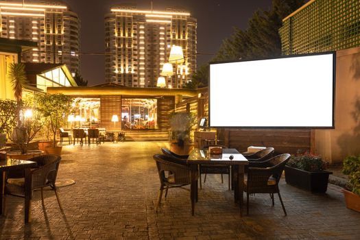 Cozy modern interior of restaurant, teahouse with white projector screen