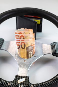 sport racing steering wheel with 50 euro banknotes with white background