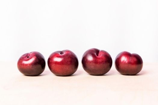 Red plum fruits on the white background isolated